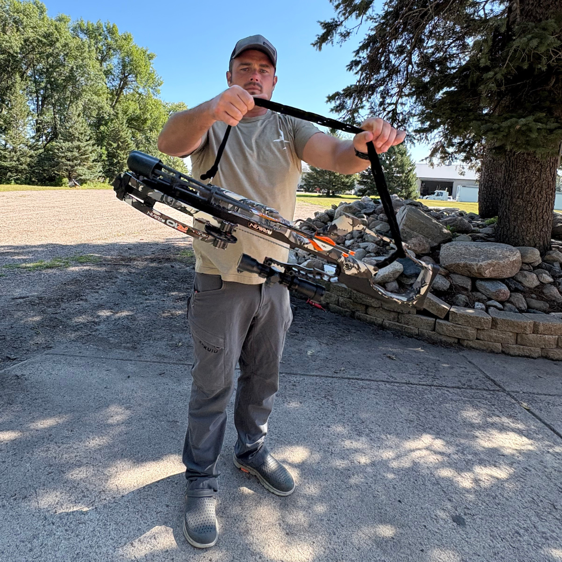 Hunter climbing a treestand with Vsling crossbow sling on a TenPoint crossbow.