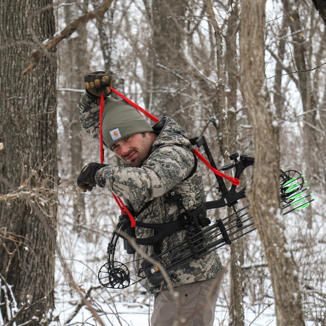 Close-up of Vsling bow sling elastic attachment secured to a Hoyt compound bow riser.