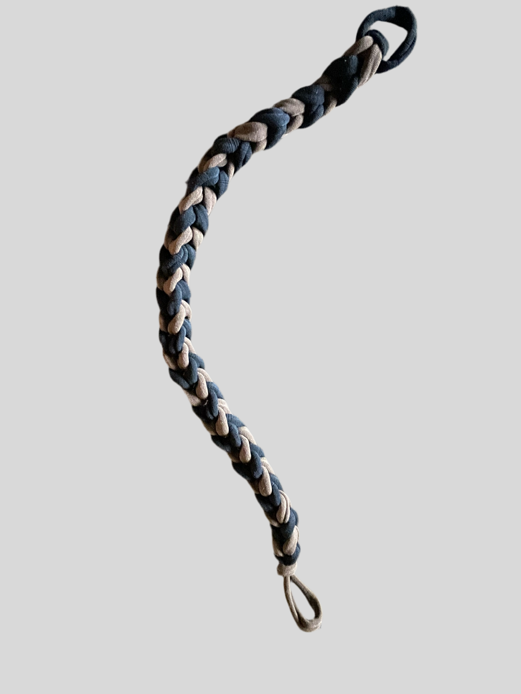 A black and brown Vsling bow sling against a gray background.