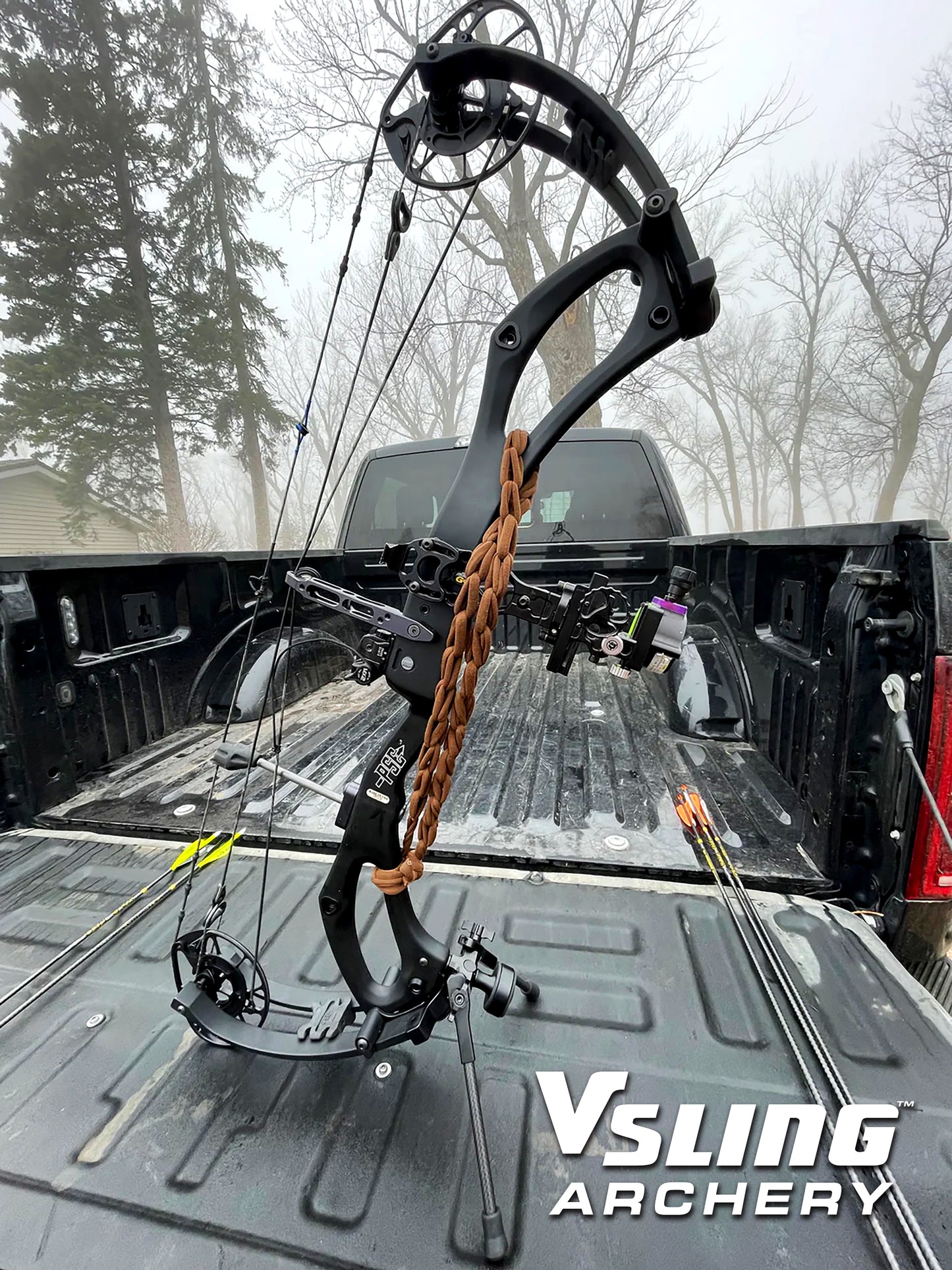 Compound bow on a truck bed with 'Vsling Archery' branding