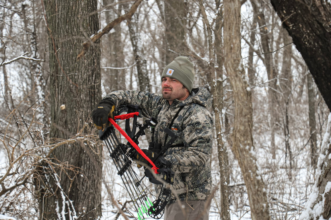 Close-up of Vsling bow sling elastic attachment secured to a Hoyt compound bow riser.