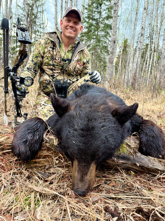 Josh with trophy black bear and Vsling bow sling on compound bow