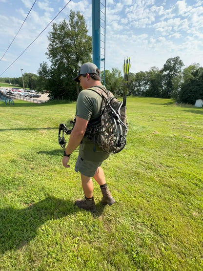Hunter with compound bow on Vsling® sling at lakeside hunting access point