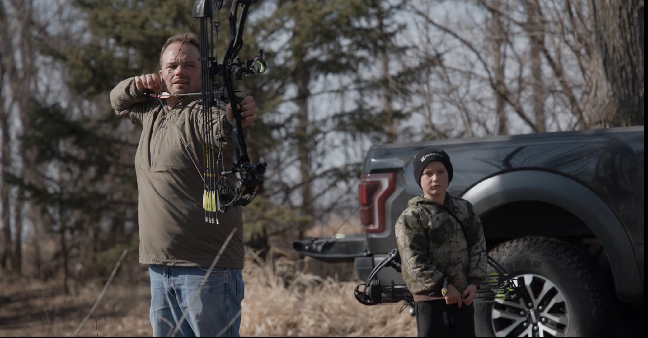 Man and child shooting bow and arrow with Vsling